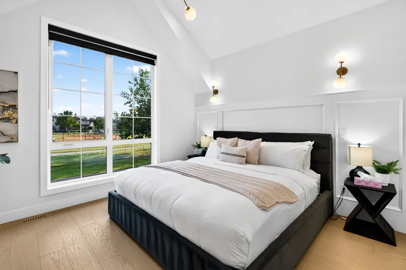 Primary bedroom with vaulted ceiling